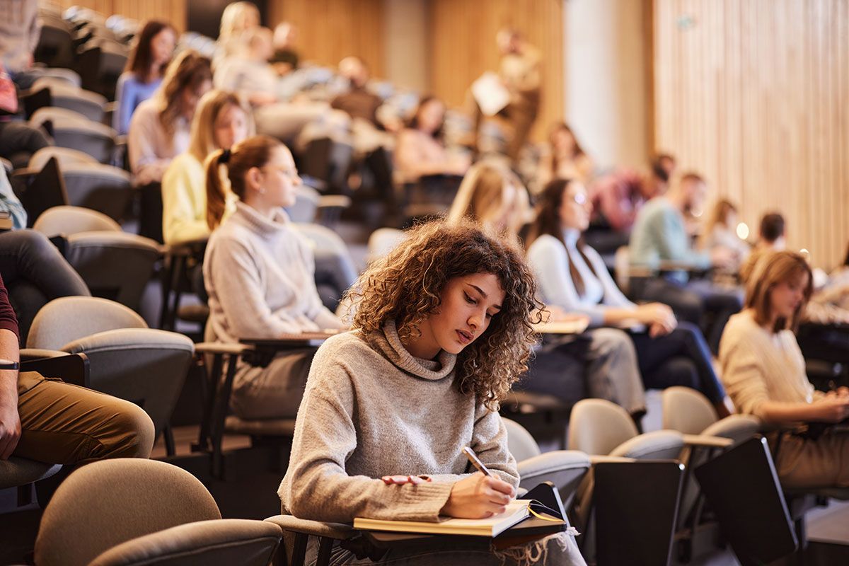 Students taking notes during a lecture
