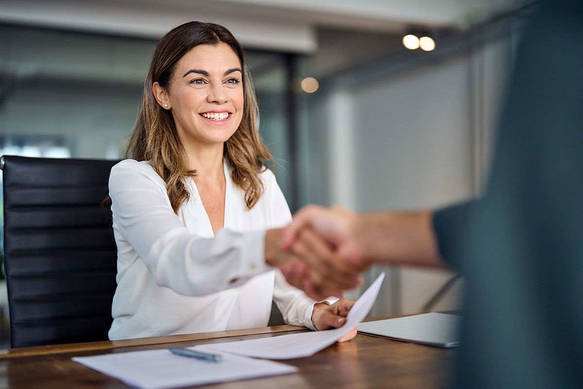 Lawyer meeting a client across a desk