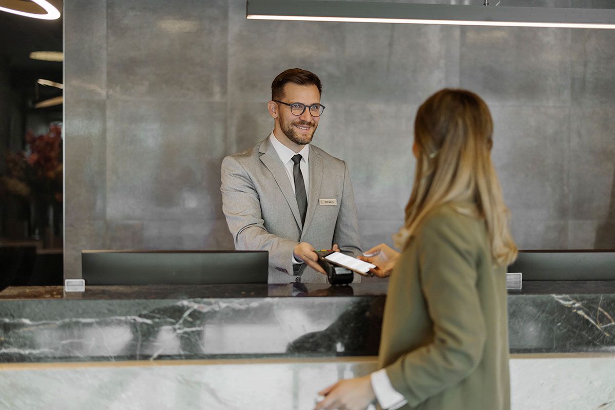 Guest checking in at a hotel reception desk