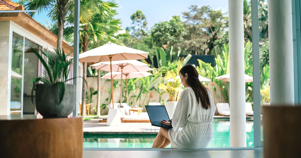 Woman browsing Luxury Websites while on holiday